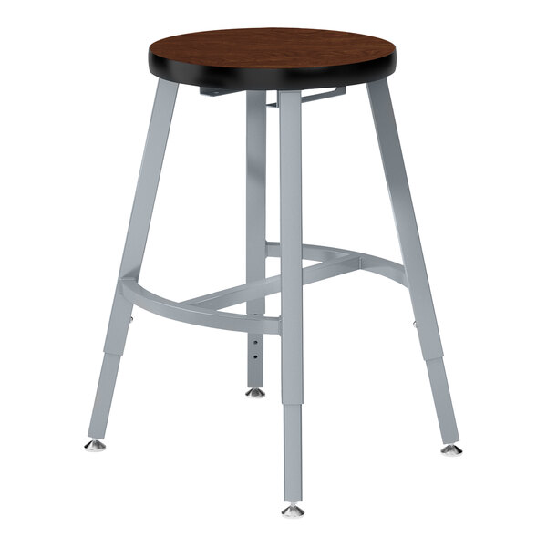 A National Public Seating Titan lab stool with a Montana walnut seat and silver legs.
