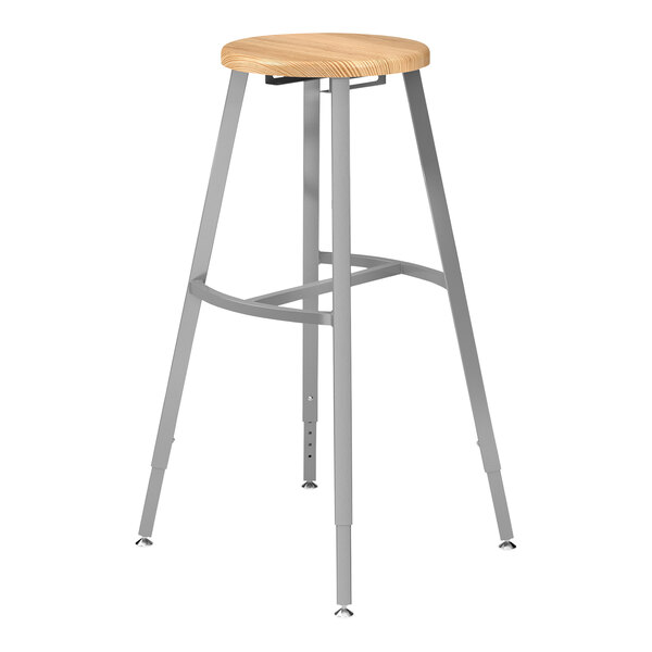 A National Public Seating steel lab stool with a wooden seat and back.