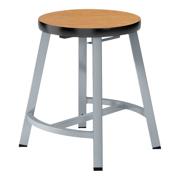 A round wooden National Public Seating lab stool with metal legs.