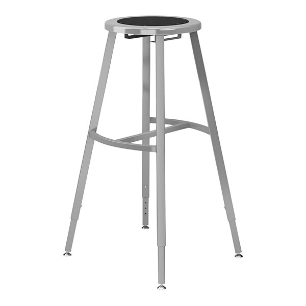 A National Public Seating Titan gray steel lab stool with a black poly seat and back.