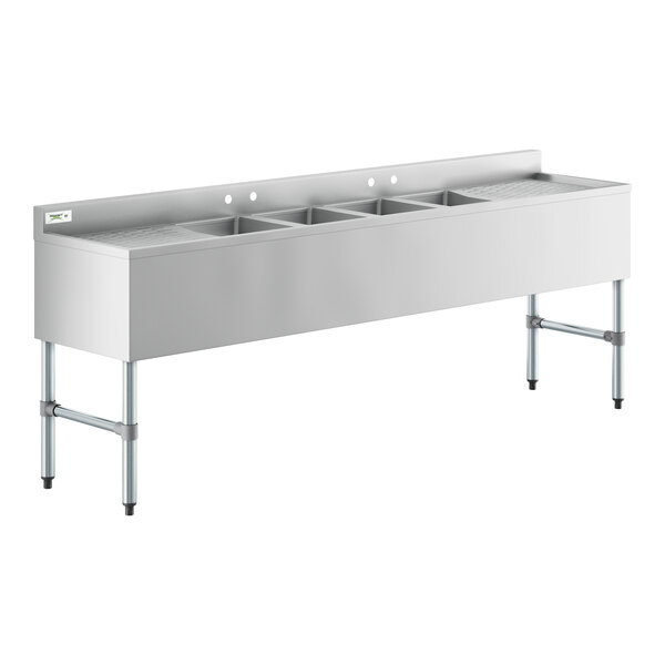 A stainless steel Regency underbar sink with four bowls and two drainboards.