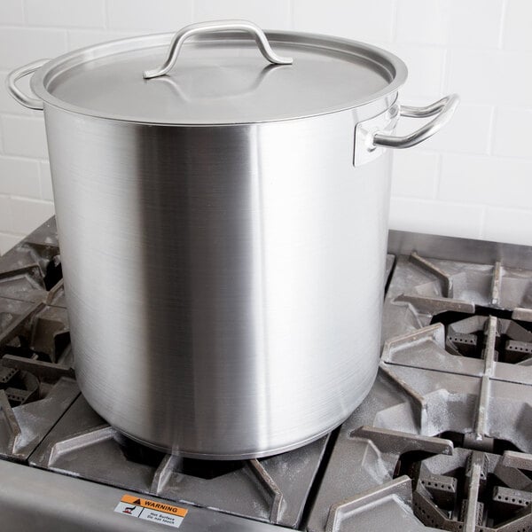 A Vollrath stainless steel stock pot on a stove.