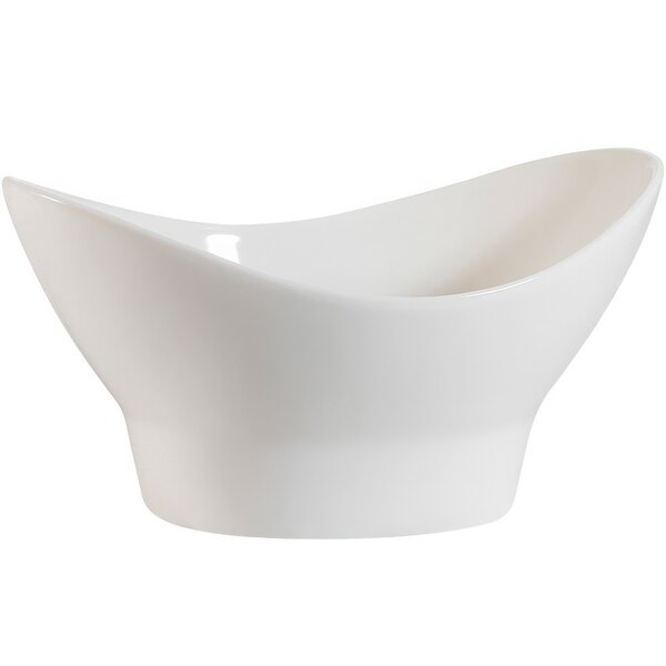 A CAC bone white porcelain footed nugget bowl with a curved edge.
