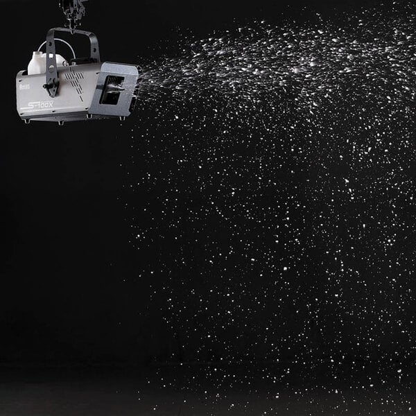 An Antari S-100X snow machine spraying snow on a black background.