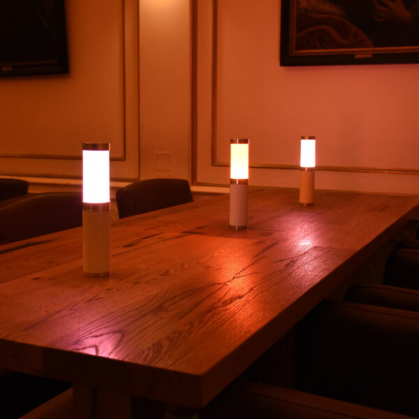A table with three Ape Labs Cream LED table lights on it.