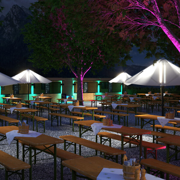 A table with Ape Labs Stick 2.0 lights on it in an outdoor catering setup.