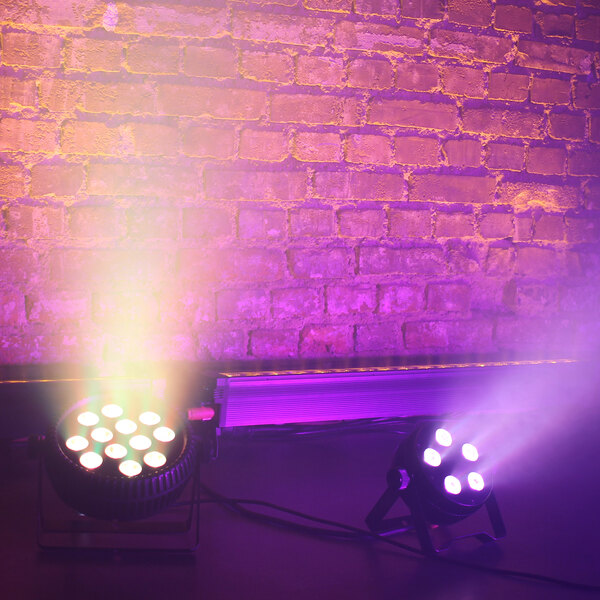 A Prost Lighting StillPar 5 LED wash light with a purple light on a brick wall.