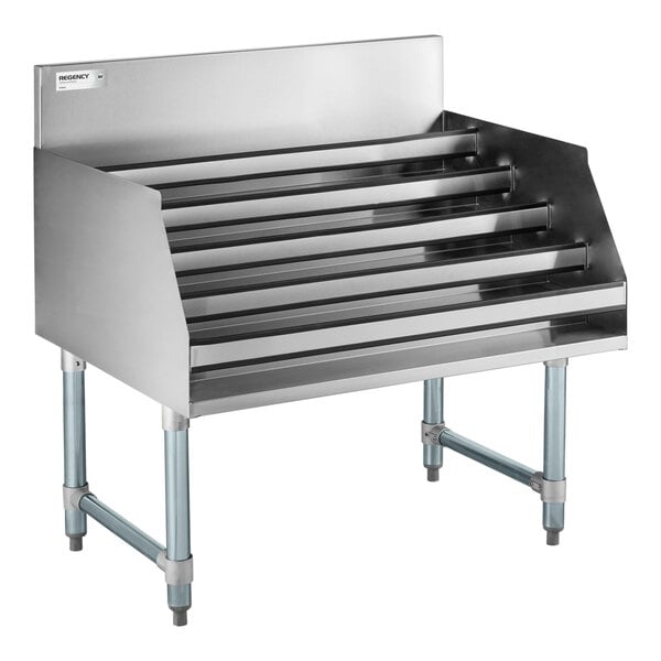 A five-tiered stainless steel rack with angled shelves and four sturdy legs, designed for displaying items.