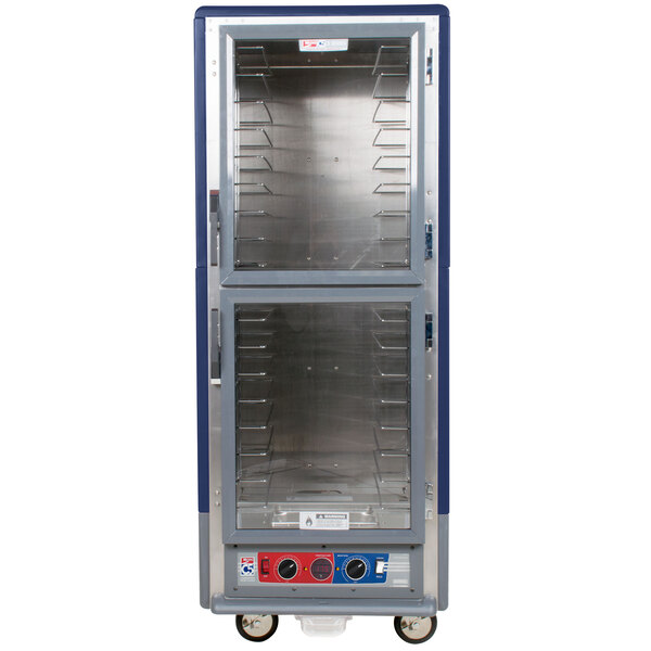 A blue Metro C5 heated holding and proofing cabinet with clear dutch doors and shelves.
