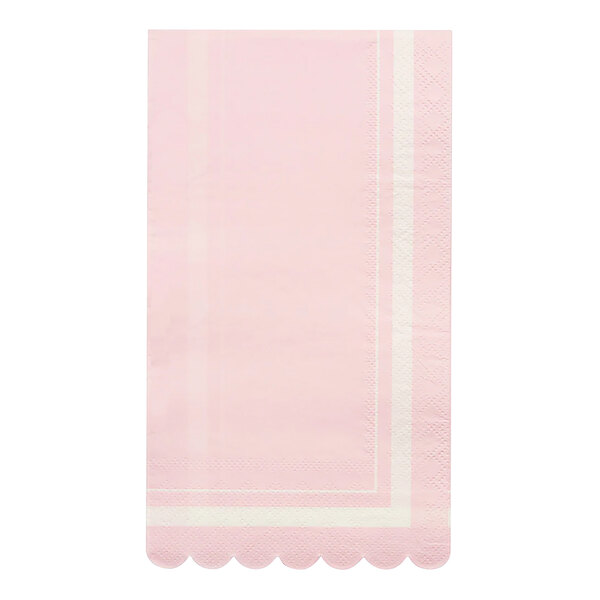 A pink paper towel with white scalloped edges.
