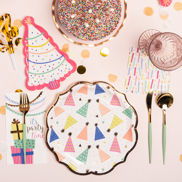 A table set with Sophistiplate birthday paper guest towels, plates, and utensils.