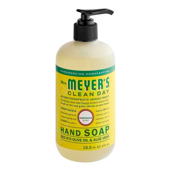 A bottle of Mrs. Meyer's Honeysuckle Scented Hand Soap with a pump.