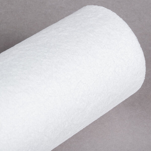 A white Manitowoc Tri-L pre-filter replacement cartridge on a gray surface.