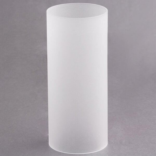 A clear glass cylinder on a gray surface.