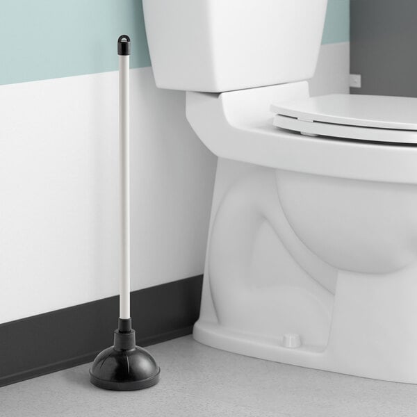 A white Lavex toilet plunger next to a white toilet.