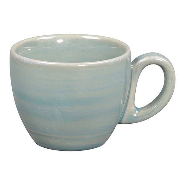 A close-up of a blue and white RAK Porcelain espresso cup with a handle.