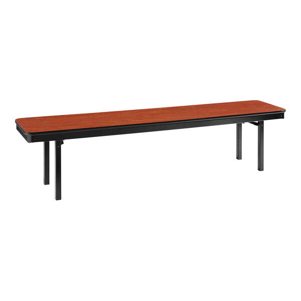 A long wooden bench with black legs and a red top.