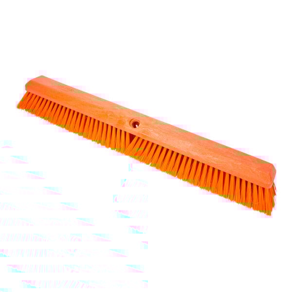 A close-up of a Carlisle Sparta orange push broom head.