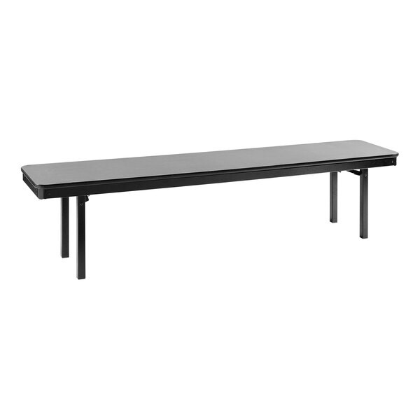 A National Public Seating gray rectangular plywood folding bench with legs.