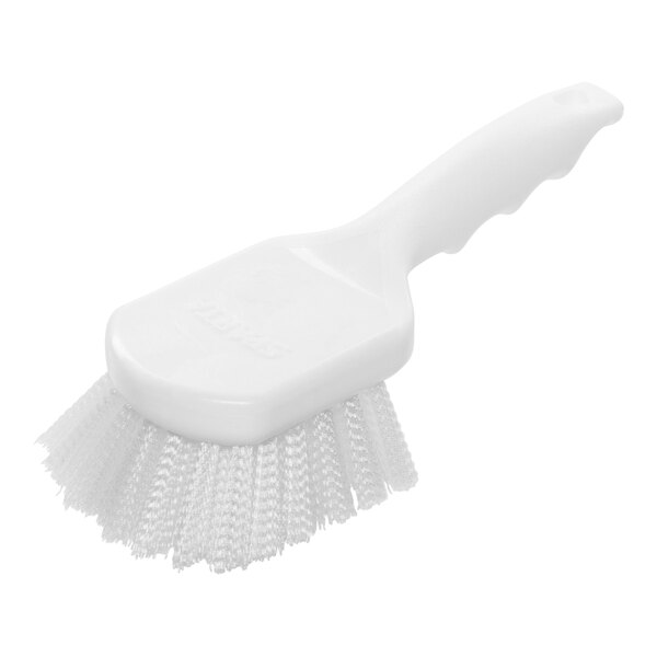 A close-up of a white Carlisle Sparta pot scrub brush with a handle.