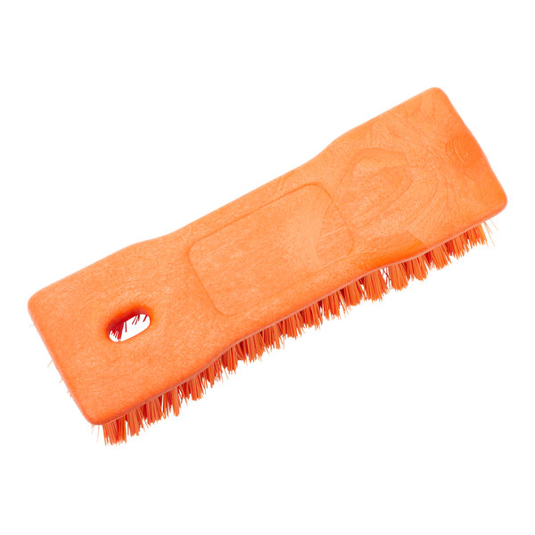 An orange Carlisle Sparta handheld scrub brush with a hole in the handle.