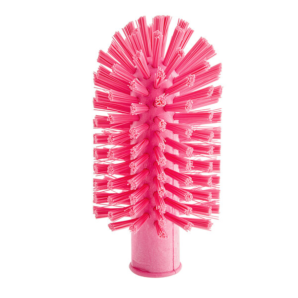 A close-up of a pink Carlisle Sparta pipe and valve brush with bristles.