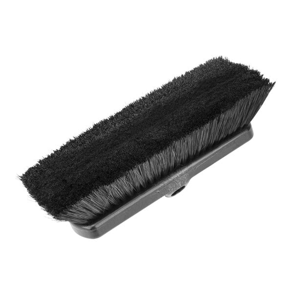 A Carlisle black deck brush with bristles and a white handle.