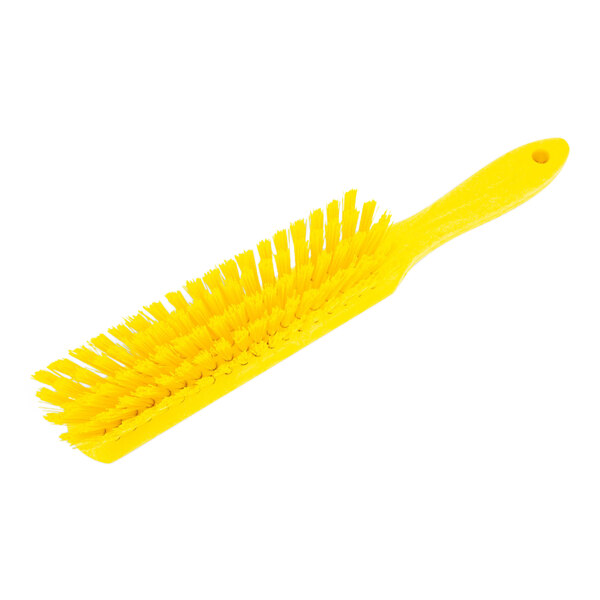 A close-up of a yellow Carlisle Sparta counter brush with a yellow plastic handle and soft bristles.