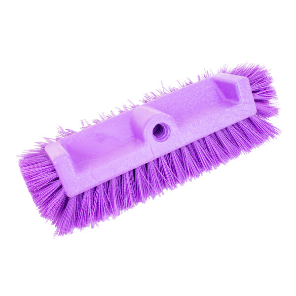 A purple Carlisle Sparta floor scrub brush with a hole in the end of the white handle.