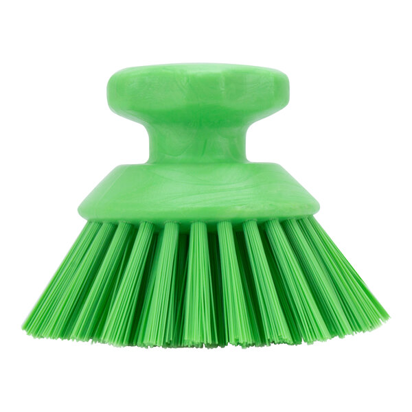 A close-up of a green round brush with a handle.