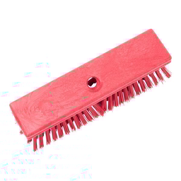 A red Carlisle Sparta deck scrub brush with a hole in it.