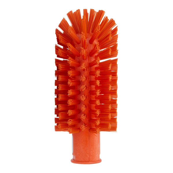 A close-up of a Carlisle orange pipe and valve brush with orange bristles.