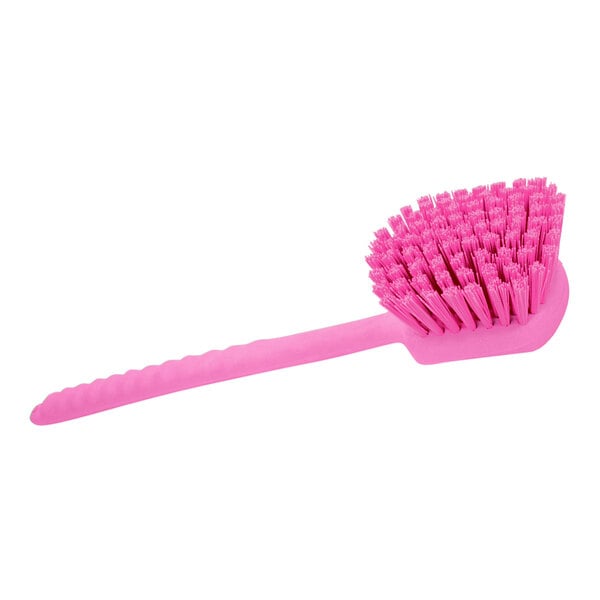 A Carlisle Sparta pink pot scrub brush with a long handle and bristles.