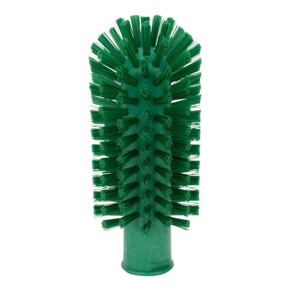 A Carlisle green brush with bristles designed for cleaning pipes and valves.