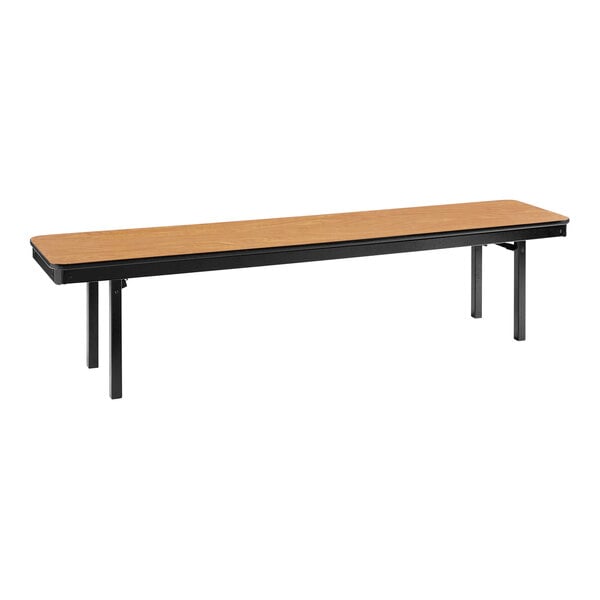 A National Public Seating Bannister Oak MDF folding bench with black legs.