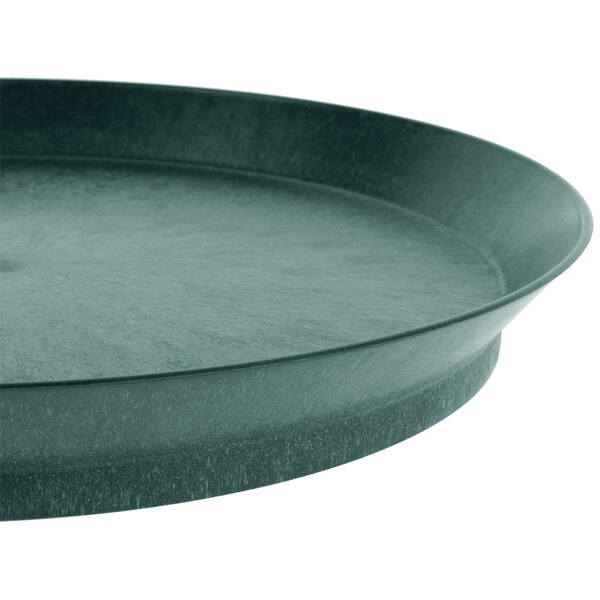 A close-up of a round green polypropylene deli server with a short black base.