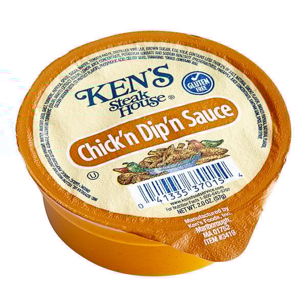 A Ken's Chick'n Dip'n Sauce 2 oz. container on a deli counter.