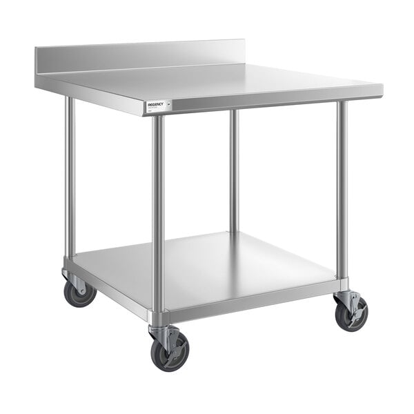 A stainless steel work table with a backsplash, undershelf, and four caster wheels.
