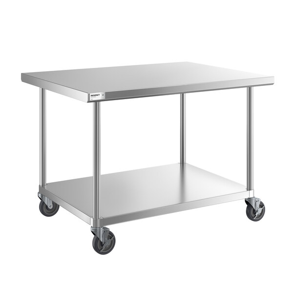 A stainless steel work table with an undershelf and four caster wheels.