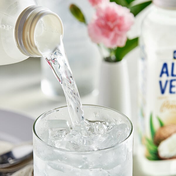 A close-up of a Goya Coconut Aloe Vera Drink bottle with a white label and black stripe.