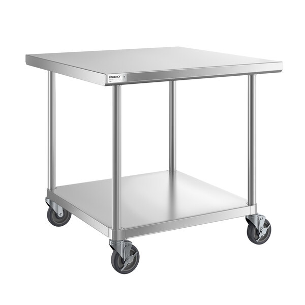 A stainless steel work table with an undershelf and four caster wheels.
