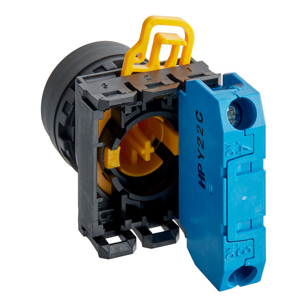 A yellow and blue Estella push button switch with a black cover.