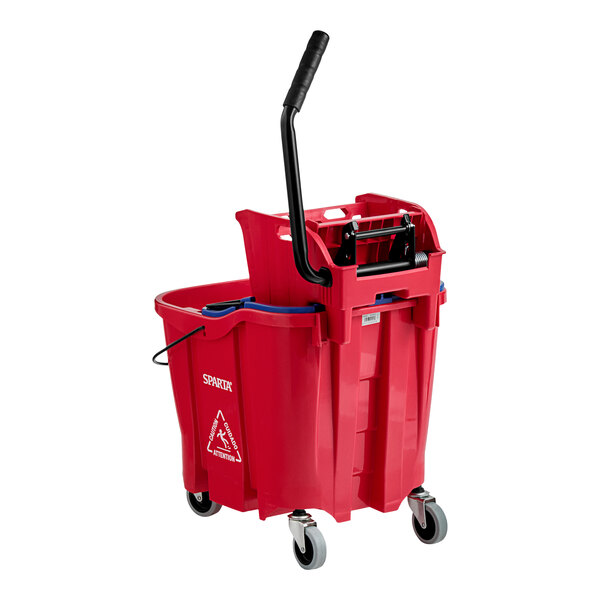 A Carlisle red mop bucket with a black handle and a side press wringer.