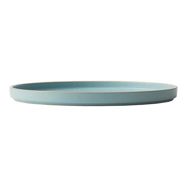 A frosted blue stoneware plate with a white rim.