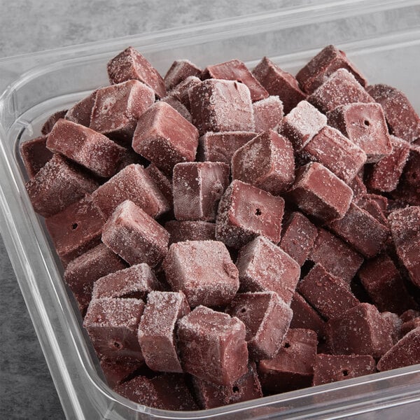 A plastic container of pink Pitaya Foods Acai berry bite-sized pieces.
