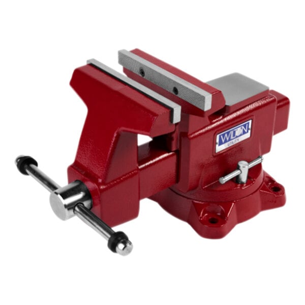 A close-up of a red Wilton bench vise with a metal handle.