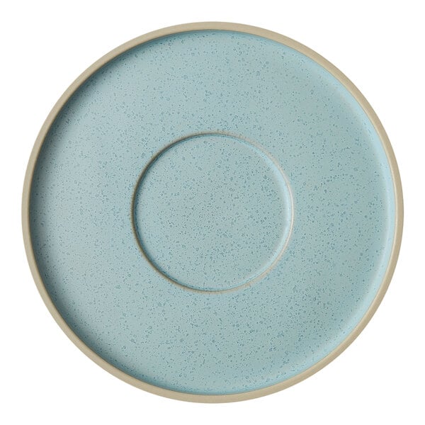 A frosted blue saucer with a white speckled rim.