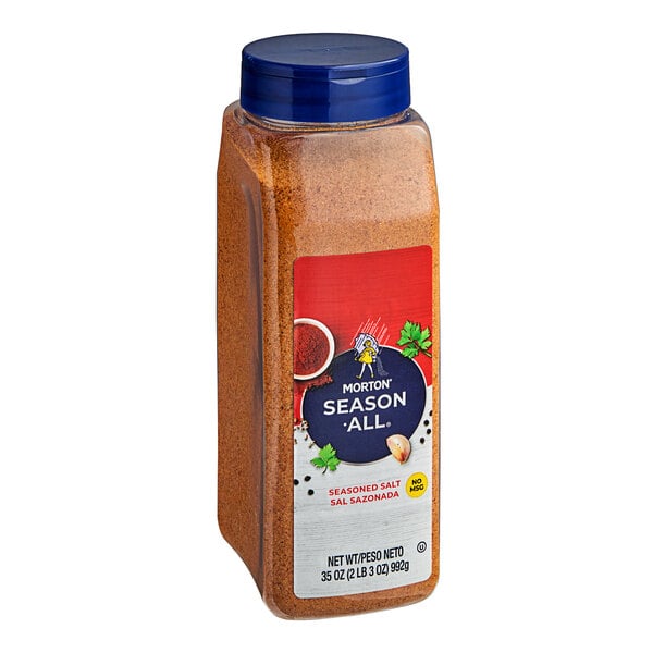 A container of Morton Season-All seasoning blend on a table.