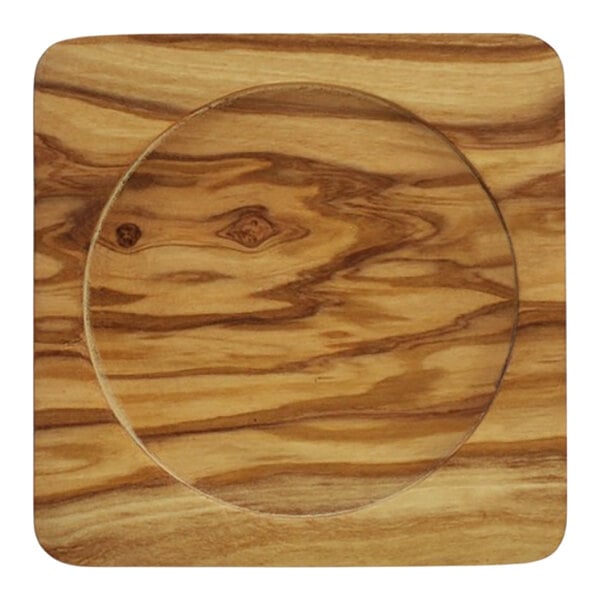 An olivewood wine coaster with a circular design in the middle.