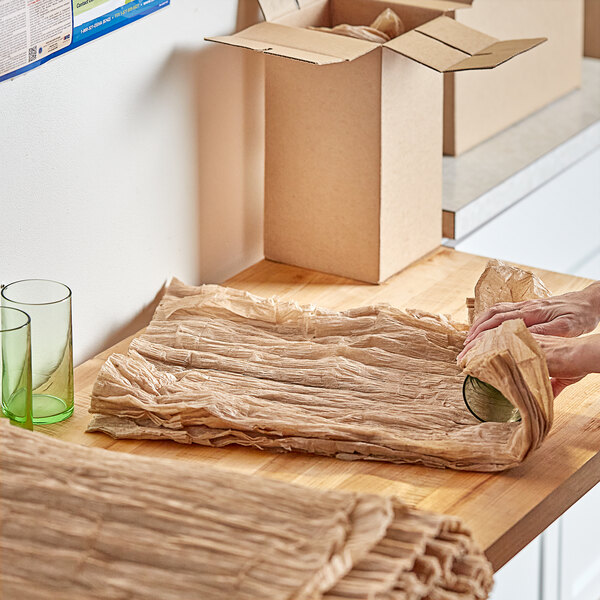 A person cutting ecoMAX Care cellulose wadding on a counter.